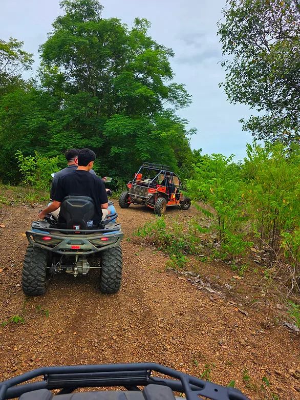 ATV and buggy climbing a hillside off-road trail in the Pattaya back-country